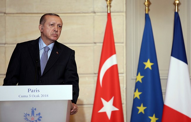 Turkish President Recep Tayyip Erdogan listens to French President Emmanuel Macron during a joint news conference at the Elysee Palace in Paris on January 5, 2018. Erdogan is in Paris for talks with Macron amid protests over press freedom and the deteriorating state of human rights in Turkey. (Pool via AP/Yasin Bulbul)