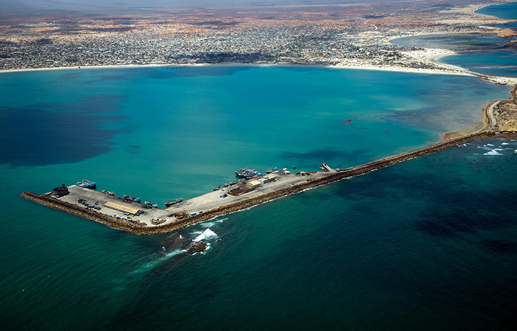 A view over the Kismayo sea-port as ships load with charcoal in Somalia in March 2013. Journalist Sabir Abdulkadir Warsame was arrested by regional security forces in the semi-autonomous state of Jubbaland on February 8, 2018, and has been held without charge in the state capital of Kismayo. (AFP/ Phil Moore)