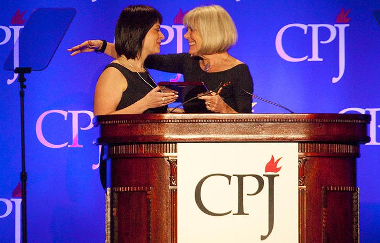 Belarusian journalist Natalya Radina, left, receives the 2011 International Press Freedom Award from Anne Garrels. Belarus has blocked access to Radina's news website, Charter 97. (Getty Images/AFP/Michael Nagle)