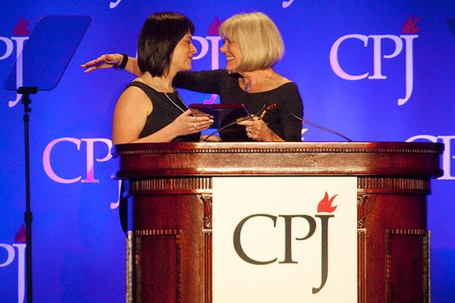 Belarusian journalist Natalya Radina, left, receives the 2011 International Press Freedom Award from Anne Garrels. Belarus has blocked access to Radina's news website, Charter 97. (Getty Images/AFP/Michael Nagle)