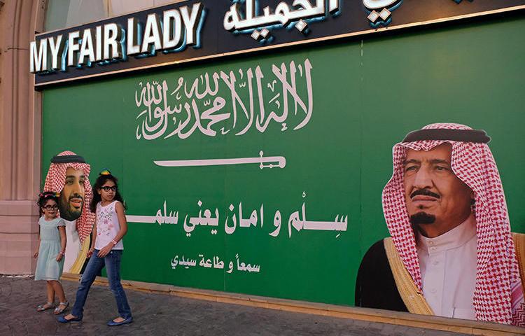 A poster in Jeddah depicts Saudi Arabia's King and Crown Prince. A Saudi court has jailed a journalist for five years for insulting the royal court. (Reuters/Reem Baeshen)