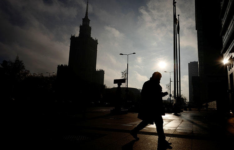 A man walks near the Palace of Culture and Science in the morning in Warsaw, Poland in November 2017. (Reuters/Kacper Pempel)
