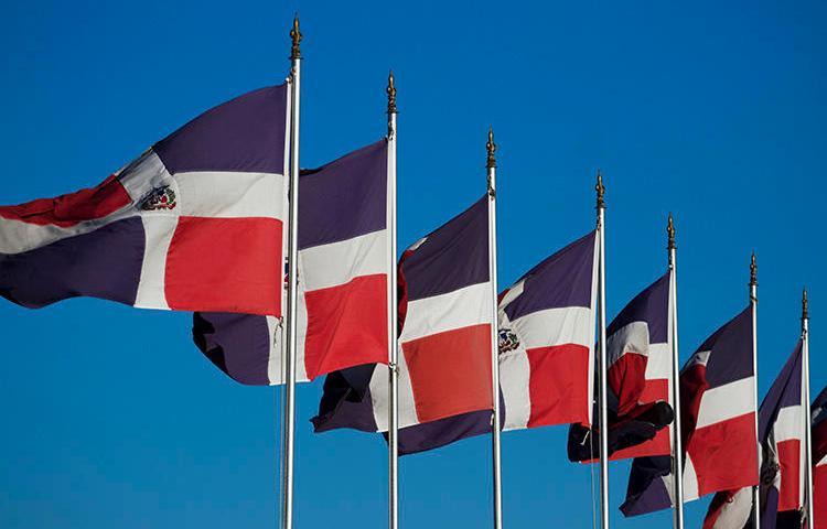 Dominican flags in Santo Domingo in 2012. A Noticias SIN reporter says threats were made against her after she reported on the murder of a fellow journalist. (AFP/Erika Santelices)