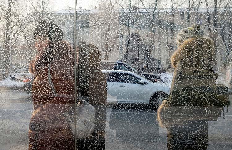 Passengers wait at a bus stop in Almaty, Kazakhstan, in early 2018. Kazakh authorities raided two news outlets and confiscated equipment in April. (Retuers/Shamil Zhumatov)