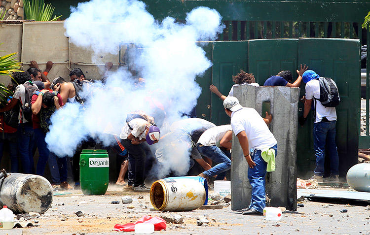 Students clash with police during protests in Managua on April 19, over planned reforms to Nicaragua's social security system. (Reuters/Oswaldo Rivas)