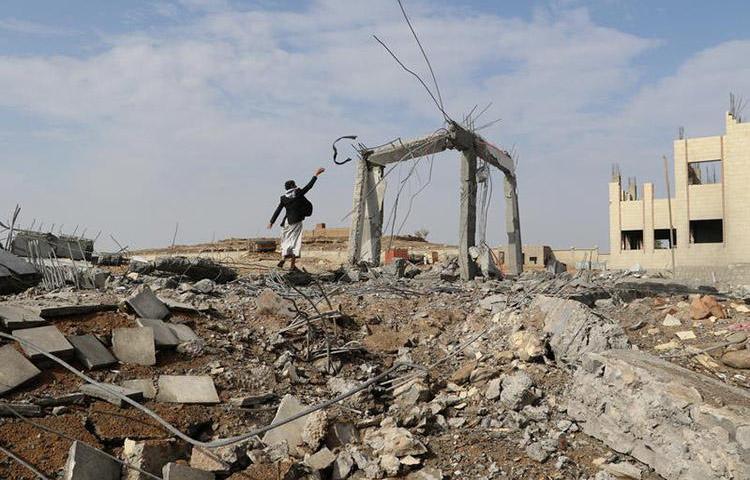 A man walks through the rubble of an airstrike in Saada, Yemen on April 12. One journalist was killed and three others were injured in a missile attack in the country's Bayda province. (Reuters/Naif Rahma)