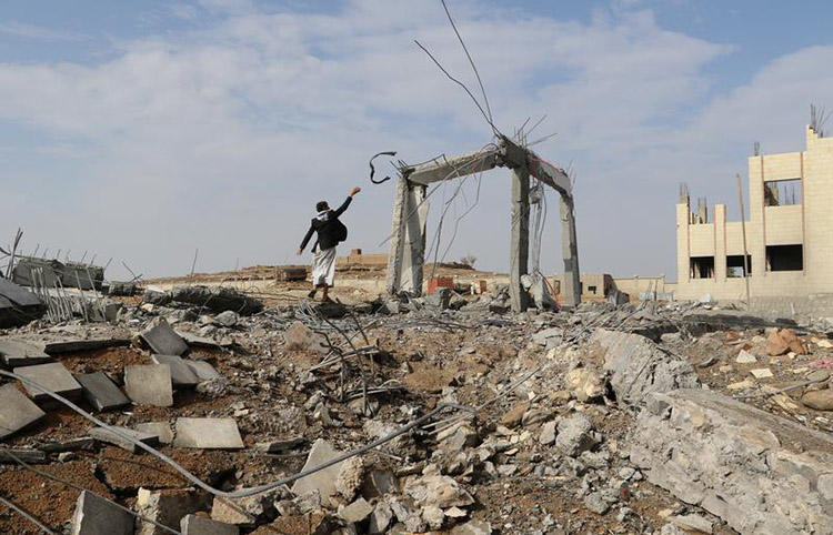 A man walks through the rubble of an airstrike in Saada, Yemen on April 12. One journalist was killed and three others were injured in a missile attack in the country's Bayda province. (Reuters/Naif Rahma)