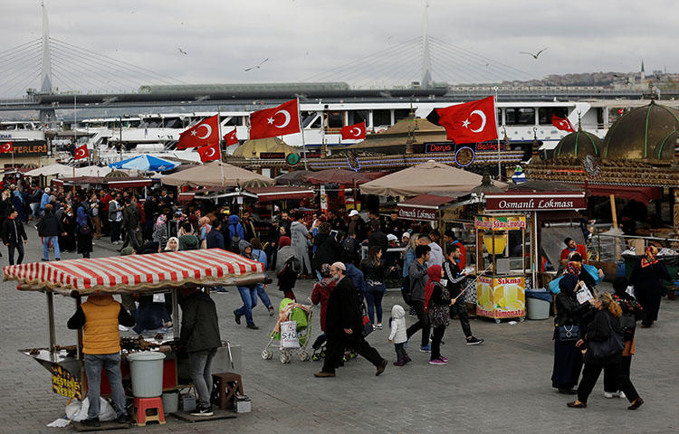 People stroll by the Golden Horn in Istanbul, Turkey on April 20, 2018. Turkish authorities sentenced to prison 10 former Feza Media Group employees on terrorism-related charges on April 30, according to reports. (Reuters/Murad Sezer)