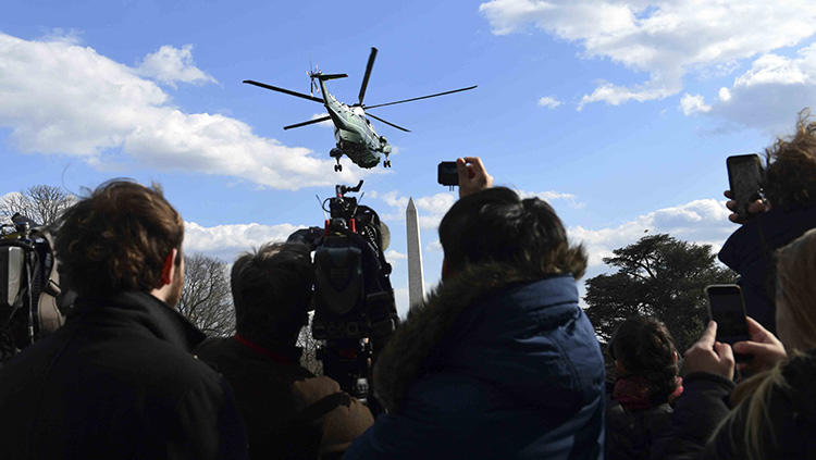 Journalists watch as Marine One, with President Donald Trump on board, lifts off from the White House in March 2018. An already hostile environment for the U.S. press has worsened since Trump came to power. (AP/Susan Walsh)