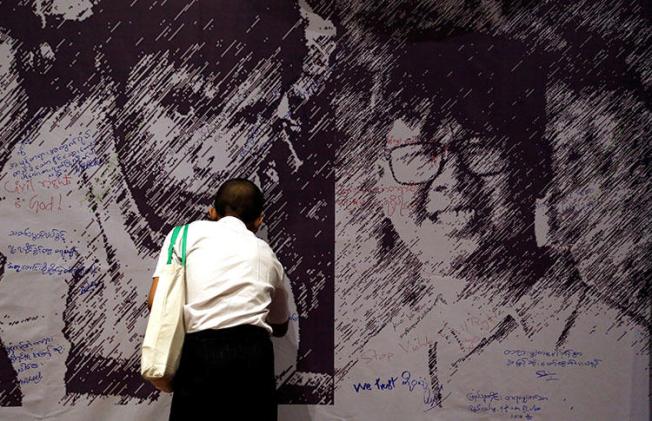 Messages of support are left on a poster depicting detained Reuters reporters Wa Lone and Kyaw Soe Oo, at a press freedom event in Yangon, Myanmar, on May 1. (Reuters/Ann Wang)