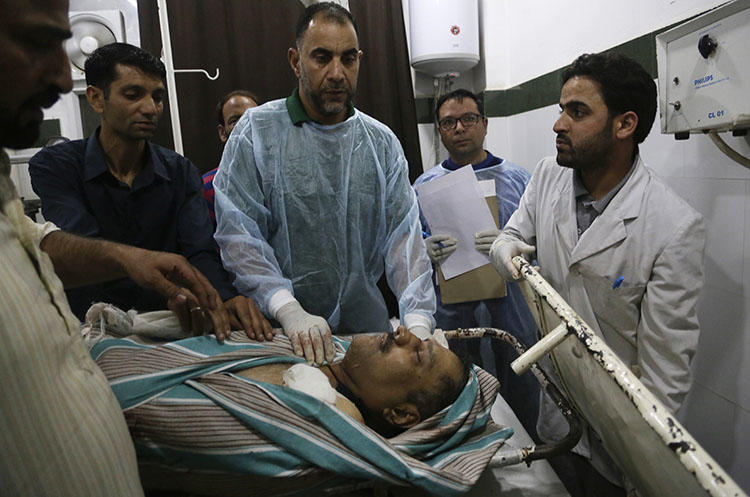 The body of journalist Shujaat Bukhari lies inside a police control room in Srinagar on June 14, 2018. Bukhari, the editor of newspaper Rising Kashmir, was shot and killed leaving his office in the city's Press Colony. (AP/Mukhtar Khan)