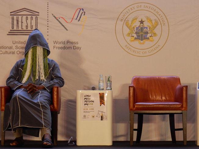 Ghanaian investigative journalist Anas Aremeyaw Anas participates in disguise on a panel at the UNESCO World Press Freedom Day event in Accra, Ghana, on May 3, 2018. One month later, Ghanaian member of parliament, Kennedy Agyapong, has been threatening Anas and those perceived as close to his undercover investigative film about corruption and football in Ghana. (CPJ/Jonathan Rozen)