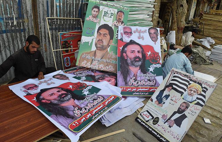 Posters of political parties for Pakistan's July 25 elections are prepared in Quetta. (AFP/Banaras Khan)