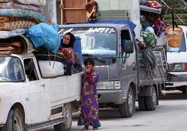 A convoy carrying displaced Syrians arrives at a checkpoint in the western countryside of Idlib province on June 1, 2018. A Syrian militia detained a reporter in western Idlib on June 24. (AFP/George Ourfalian)