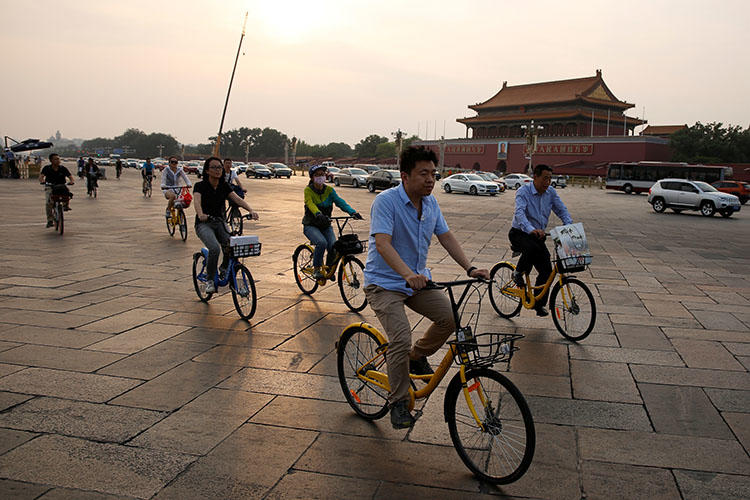 Cyclists cross Tiananmen Square in Beijing, China on June 16, 2017. A Sichuan province court on July 13, 2018, sentenced Chinese freelance political cartoonist Jiang Yefei to prison for six years and six months on charges of