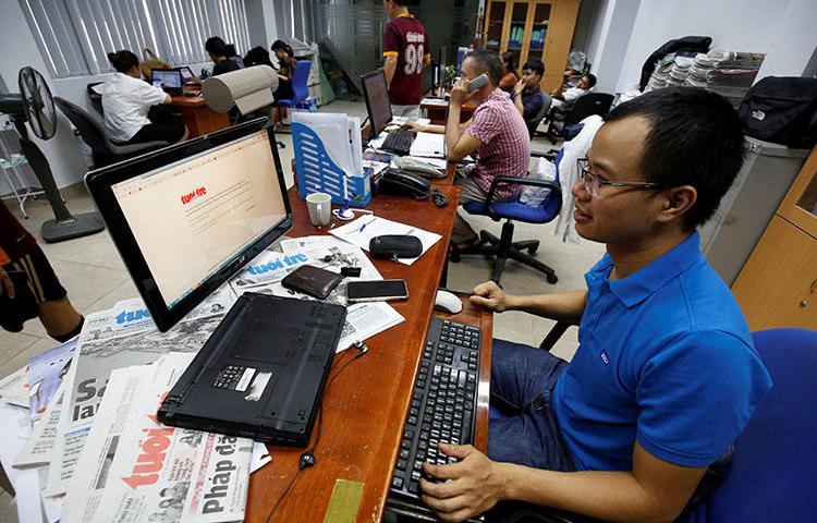 A journalist shows the banned online edition of Tuoi Tre at the newspaper's office in Hanoi, Vietnam, on July 17, 2018. (Reuters/Nguyen Huy Kham)