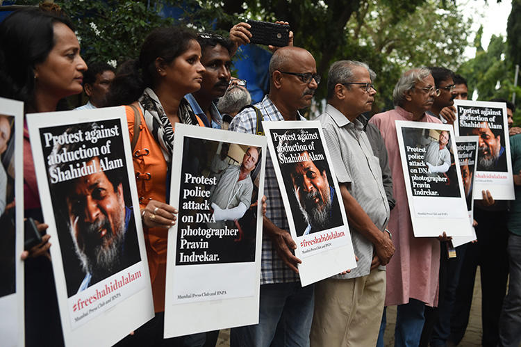 Indian photographers and journalists gather outside the Mumbai Press Club to protest against the July 27 attack on photojournalist Pravin Indrekar by police in the Indian state of Gujarat, in Mumbai on August 7, 2018. They were also protesting the recent arrest of photojournalist Shahidul Alam in Dhaka, Bangladesh. (AFP/Punit Paranjpe)