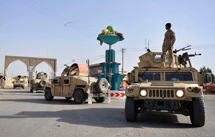 Afghan security personnel patrol in Ghazni city. Fighting between the Taliban and Afghan forces in and around Ghazni has left at least 20 civilians dead since August 10, the AP reported. (AP/Mohammad Anwar Danishyar)