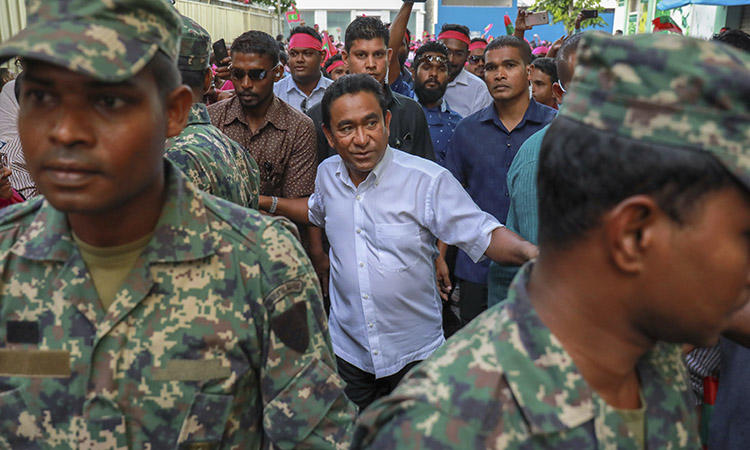 President Yameen, center, surrounded by his body guards in the capital, Malé, in February 2018. The president was criticized today for comments he made about missing Maldives journalist Rilwan. (AP/Mohamed Sharuhaan/File)