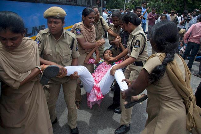 Indian police detain a protester demonstrating against the arrest of activists in Hyderabad, India, on August 29, 2018. Two journalists' homes were raided in conjunction with the arrests. (AP/Mahesh Kumar A.)