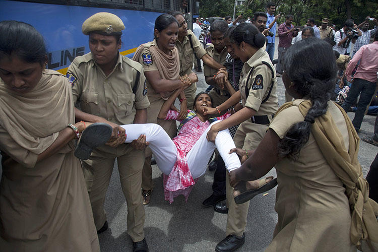 Indian police detain a protester demonstrating against the arrest of activists in Hyderabad, India, on August 29, 2018. Two journalists' homes were raided in conjunction with the arrests. (AP/Mahesh Kumar A.)