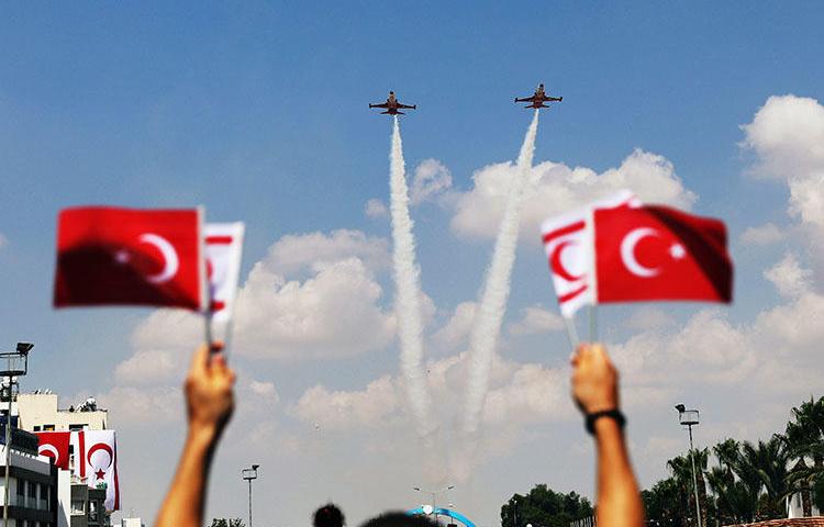 Turkish aircraft fly over a parade in the Turkish Cypriot northern part of the divided city of Nicosia, Cyprus on July 20, 2018. The parade marked the 1974 Turkish invasion of Cyprus. (Reuters/Yiannis Kourtoglou)