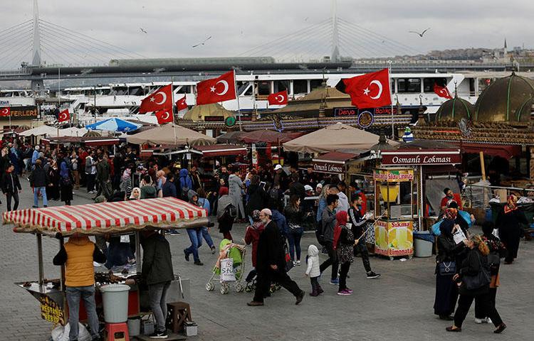 People stroll by the Golden Horn in Istanbul, Turkey on April 20, 2018. Turkey's press crackdown continues, with more journalists arrested or charged for reporting critically.(Reuters/Murad Sezer)