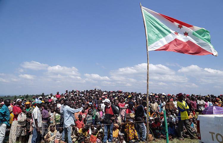 Residents gather for a ceremony in Bugendana in June 2018 to mark the adoption of Burundi's new constitution. Three radio journalists covering a land dispute in the country's capital in August 2018 say police harassed and attacked them. (STR/AFP)