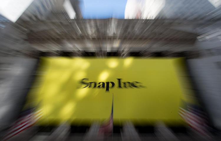 A Snap banner covers the facade of the New York Stock Exchange in March 2017. The social media company's transparency report shows it received and complied with three government takedown requests for the Al-Jazeera Discover channel. (AFP/Bryan R. Smith)