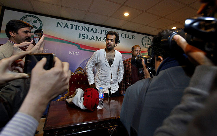 Reporter Taha Siddiqui, center, speaks at a January 2018 press conference about an attempted kidnapping that he believes is connected to his reporting on Pakistan’s military. (AP/Anjum Naveed)