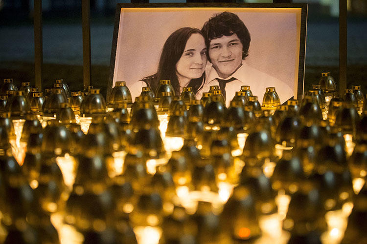 A memorial for investigative reporter Ján Kuciak and his fiancée, Martina Kušnírová, is held in Bratislava in February. Slovak police in September charged three people with the couple's murder. (AP/Bundas Engler/file)