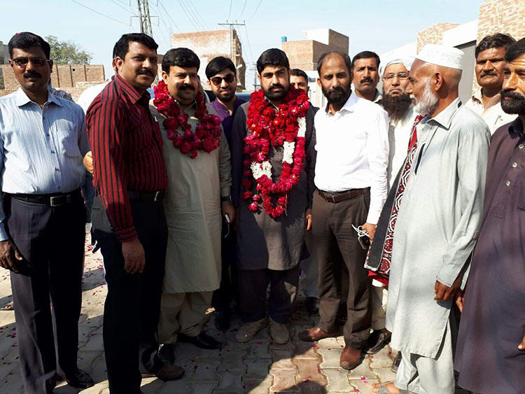 Authorities detained Hafiz Husnain Raza, pictured center in garland, for nearly two years before dropping all charges. The reporter covered land disputes between farmers and the military. (Hassan Raza)