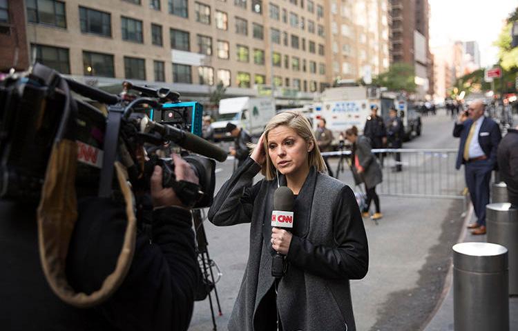 CNN correspondent Kate Bolduan reports from outside the Time Warner Building in New York City on October 24, as police remove an explosive device from the CNN offices. (AP/Kevin Hagen)