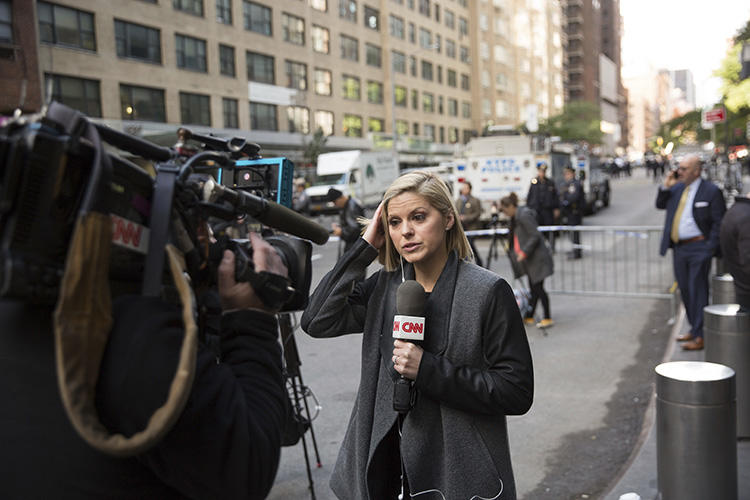 CNN correspondent Kate Bolduan reports from outside the Time Warner Building in New York City on October 24, as police remove an explosive device from the CNN offices. (AP/Kevin Hagen)