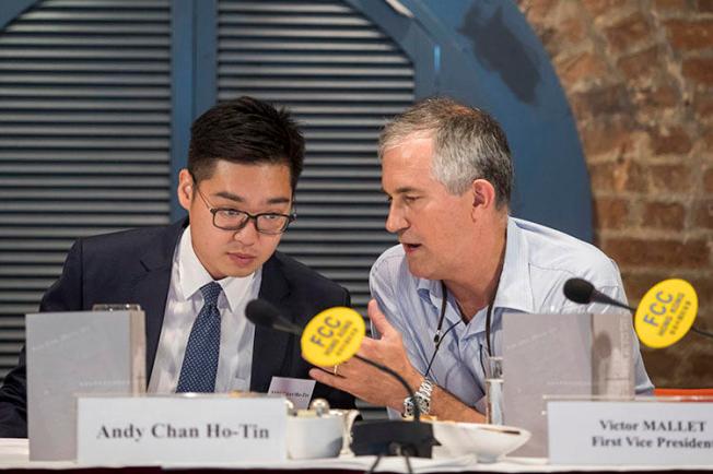 In this August 14, 2018, photo, Victor Mallet, Financial Times Asia news editor, right, speaks with Andy Chan, founder of the Hong Kong National Party, at the Foreign Correspondents Club in Hong Kong. Hong Kong's government has declined to renew Mallet's work visa. (AP)