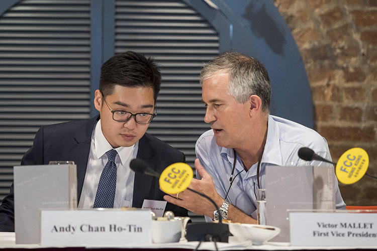 In this August 14, 2018, photo, Victor Mallet, Financial Times Asia news editor, right, speaks with Andy Chan, founder of the Hong Kong National Party, at the Foreign Correspondents Club in Hong Kong. Hong Kong's government has declined to renew Mallet's work visa. (AP)