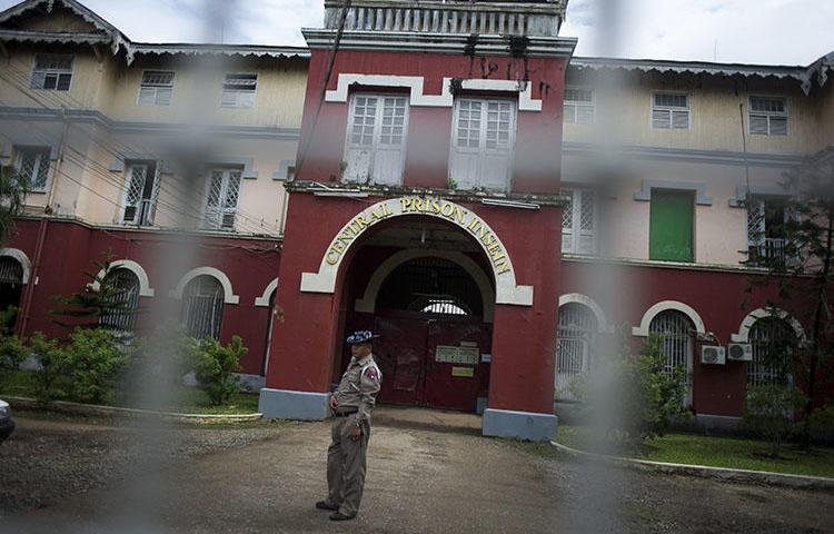 An officer stand guards before Insein prison in Yangon, Myanmar. Three journalists from Eleven Media were remanded to the prison after raising questions about public spending in Yangon. (Ye Aung Thu/AFP)