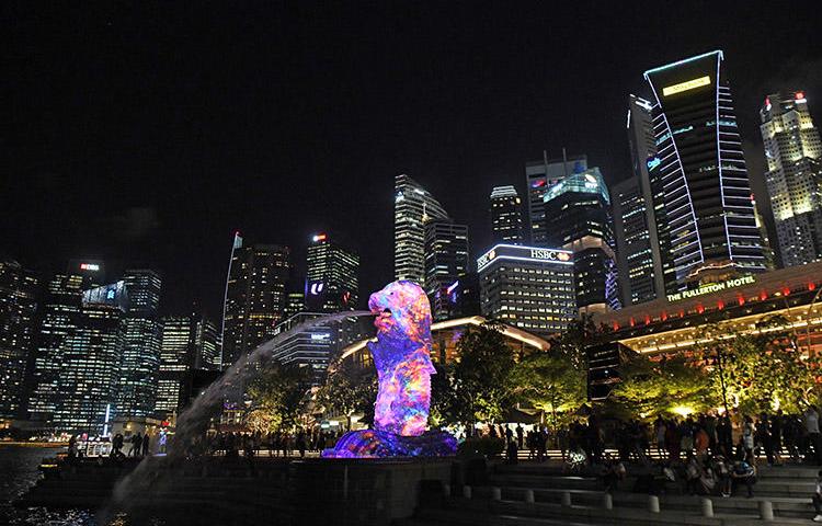 Singapore's Merlion statue is lit up in front of the city skyline in March 2018. Authorities are investigating a criminal defamation complaint against an independent news website. (AFP/Roslan Rahman)