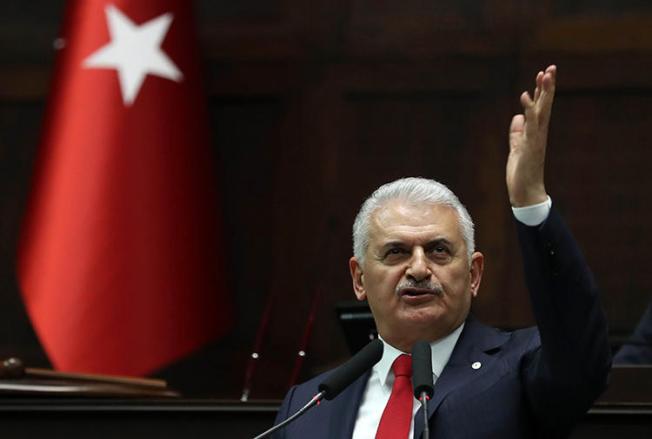 Binali Yıldırım, pictured giving a speech at Turkey's Grand Assembly in March 2018. A court ordered the daily Evrensel to pay damages to the former prime minister over its caricature of him. (AFP/Adem Altan)