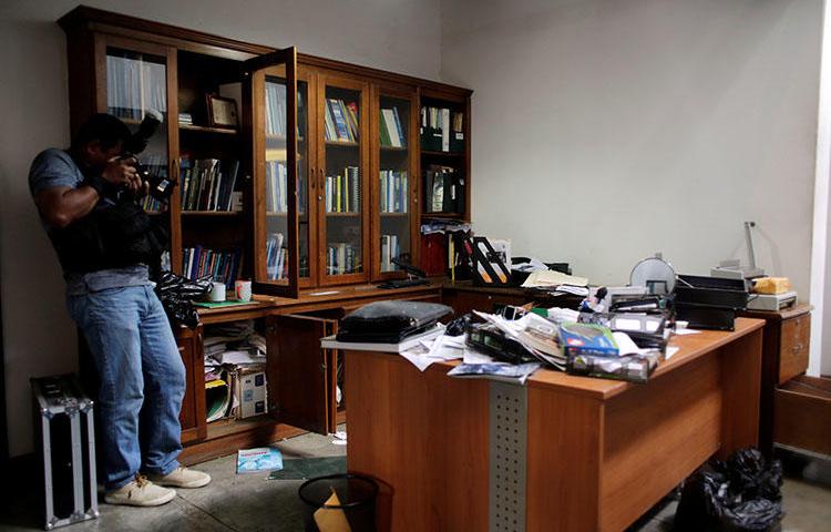 Un fotógrafo local hace un video de la oficina del periodista Carlos Fernando Chamorro, el día siguiente de ser allanada por la policía nacional en Managua, Nicaragua. (REUTERS/Oswaldo Rivas).