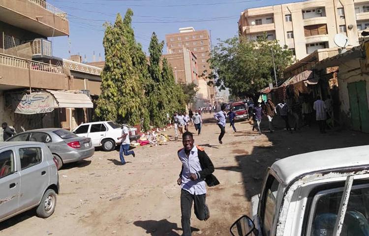 Sudanese protesters run away from tear gas during a demonstration in Khartoum, Sudan's capital, on December 31, 2018. Sudan has detained several opposition journalists amid the ongoing protests. (AFP)