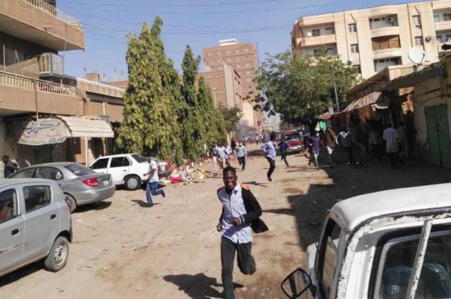 Sudanese protesters run away from tear gas during a demonstration in Khartoum, Sudan's capital, on December 31, 2018. Sudan has detained several opposition journalists amid the ongoing protests. (AFP)