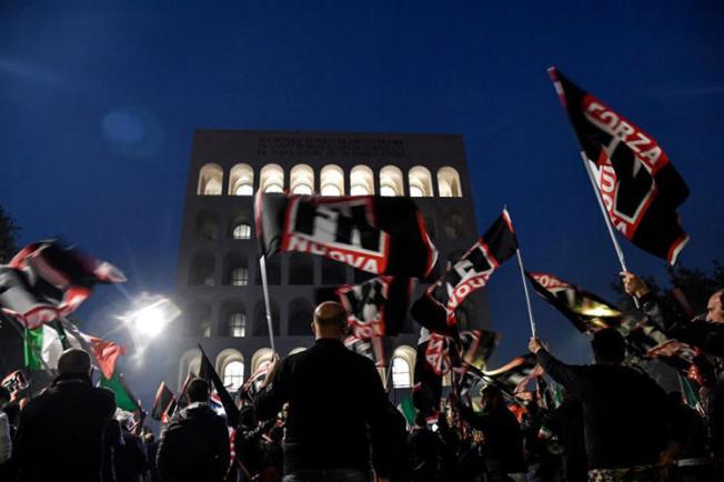 Members of the Italian far-right political party Forza Nuova wave flags during a demonstration on November 4, 2017, in central Rome. On January 7, 2019, members of Forza Nouva and other extremist groups attacked two reporters covering an event in Rome. (AFP/Andreas Solaro)