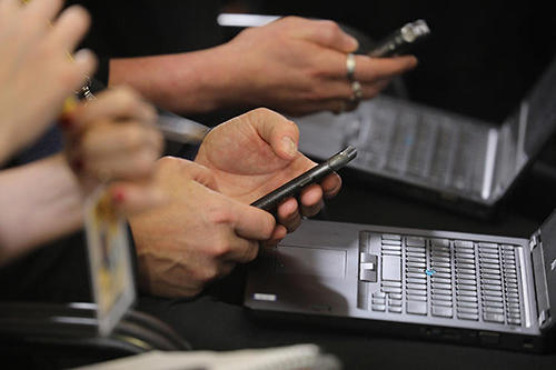 Journalists work on digital equipment during a press conference. (AFP/Ludovic Marin)