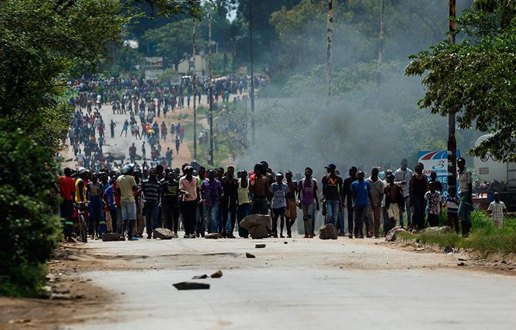 Protesters block the main route to Zimbabwe's capital Harare from Epworth township on January 14, 2019, after the government more than doubled the price of fuel. On January 15, CPJ joined more than 20 rights organizations and the #KeepItOn Coalition to call for authorities in Zimbabwe to restore internet and social media services. (AFP/Jekesai Njikizana)