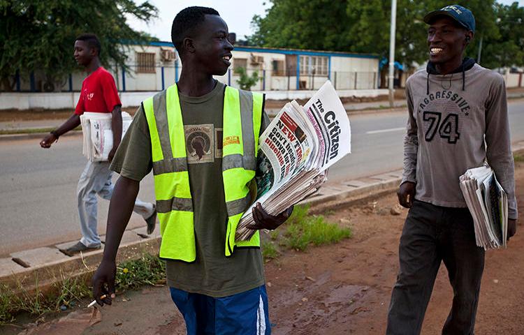 Newspaper vendors chat on their way to sell newspapers in Juba, South Sudan. Recently, the South Sudanese government has attempted to restrict local newspapers' ability to cover the ongoing political crisis in neighboring Sudan. (Adriane Ohanesian/Reuters)