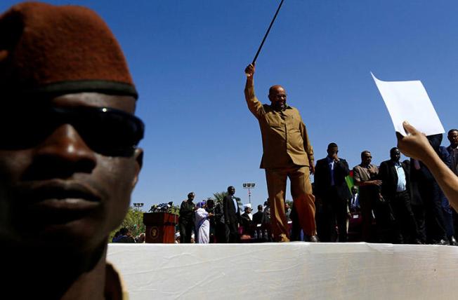 President Omar al-Bashir waves to supporters during a rally in Khartoum on January 9. Sudanese authorities have revoked the credentials of at least six journalists working for international outlets. (Reuters/Mohamed Nureldin Abdallah)