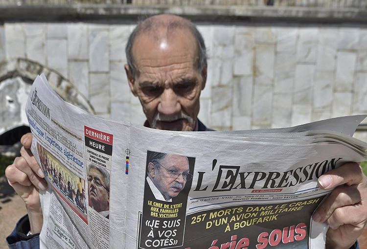 An Algerian man reads a newspaper in the capital, Algiers, on April 12, 2018. Adlène Mellah, founder of online news outlets Dzair Presse and Algerie-Direct, was recently handed a six-month suspended prison sentence in Algiers (Ryad Kramdi/AFP)