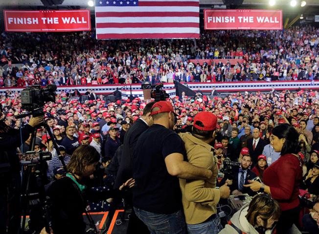 A man is restrained after he began shoving members of the media during a rally for President Donald Trump at the El Paso County Coliseum in El Paso, Texas, on February 11, 2019. (AP Photo/Eric Gay)