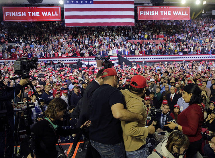 A man is restrained after he began shoving members of the media during a rally for President Donald Trump at the El Paso County Coliseum in El Paso, Texas, on February 11, 2019. (AP Photo/Eric Gay)